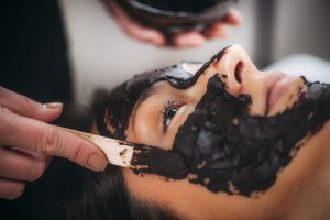Beautician Applying Chocolate Mask on Woman’s Face.